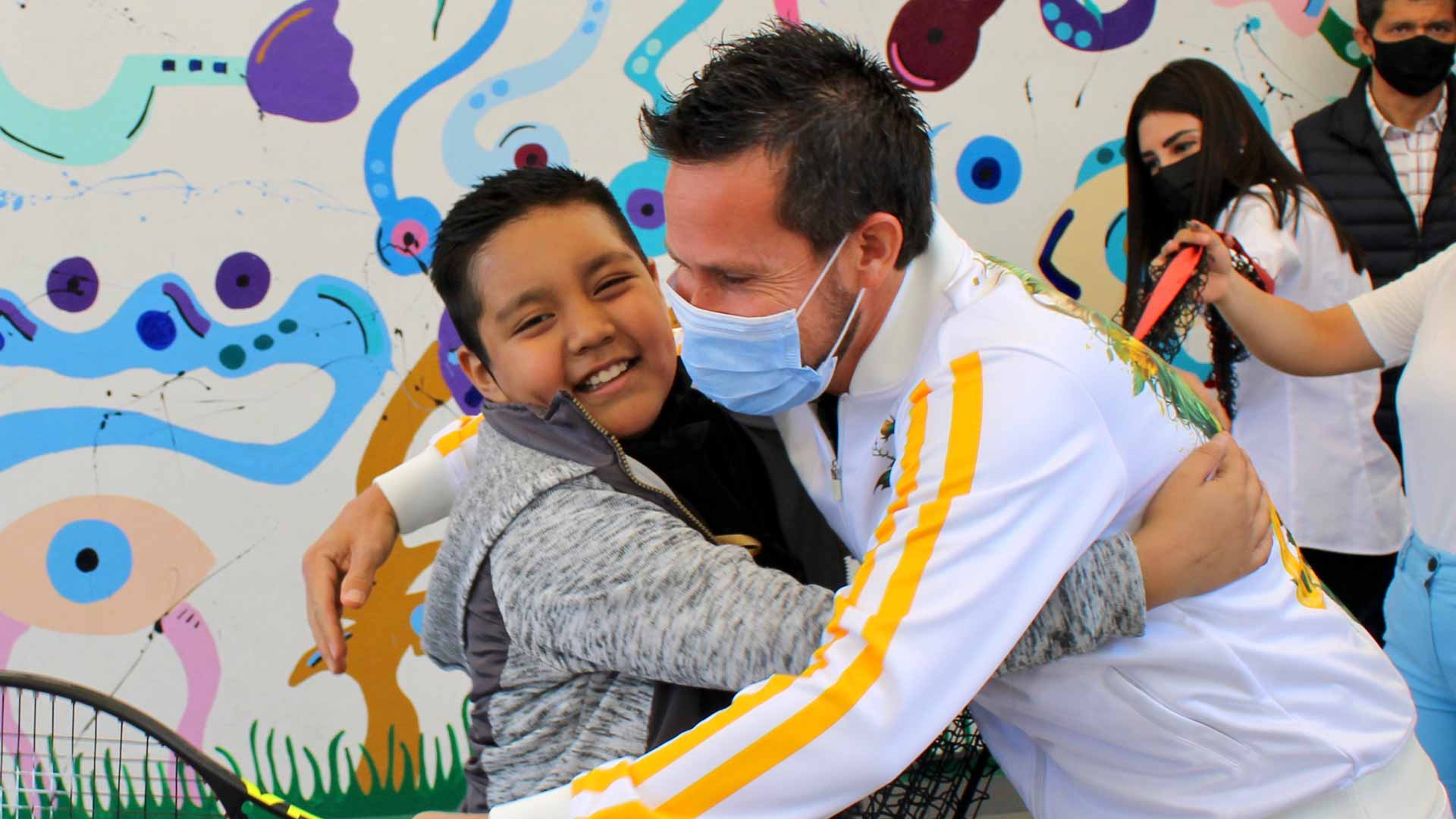 Miguel Angel Reyes-Varela hugs a child during charity activities in Mexico City.