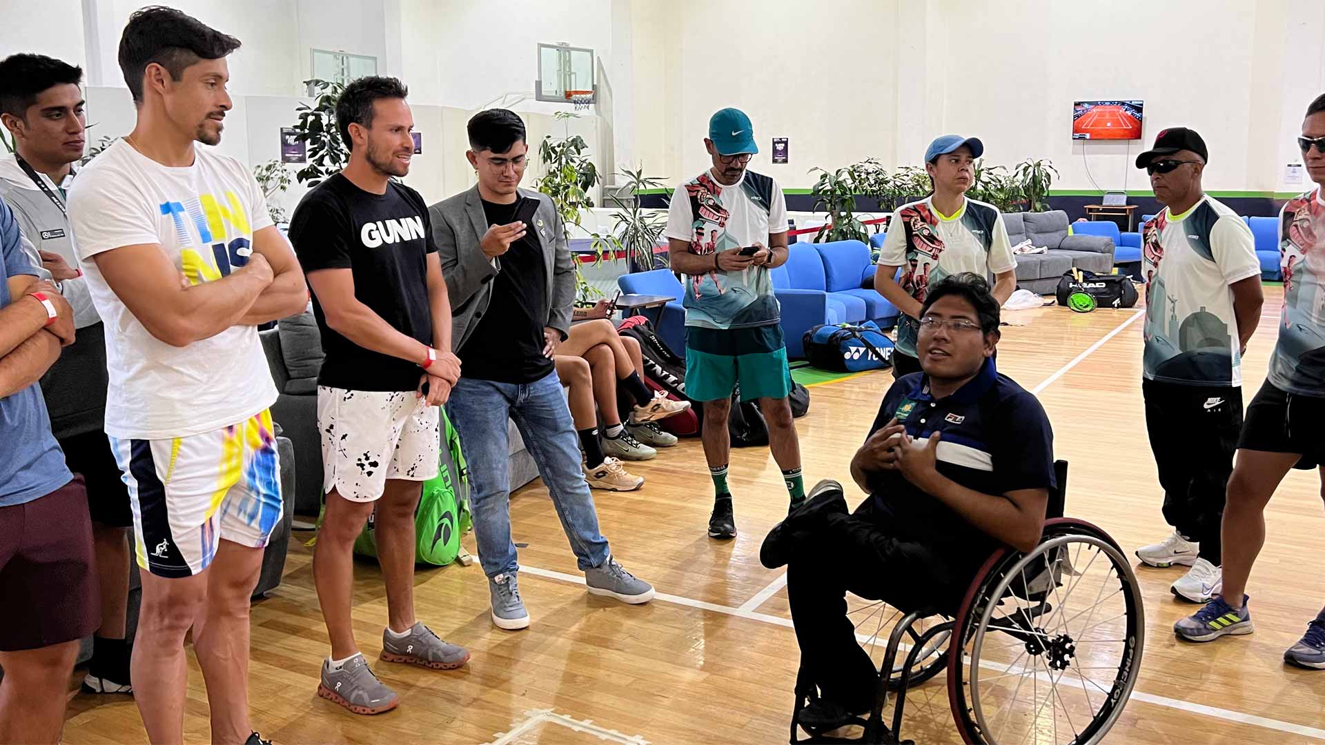 Wheelchair tennis player Carlos Muro speaks with ATP Challenger Tour players.