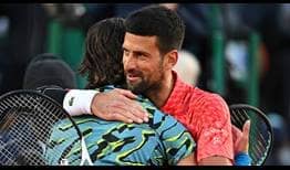 Novak Djokovic hugs Lorenzo Musetti after their match Thursday in Monte-Carlo.