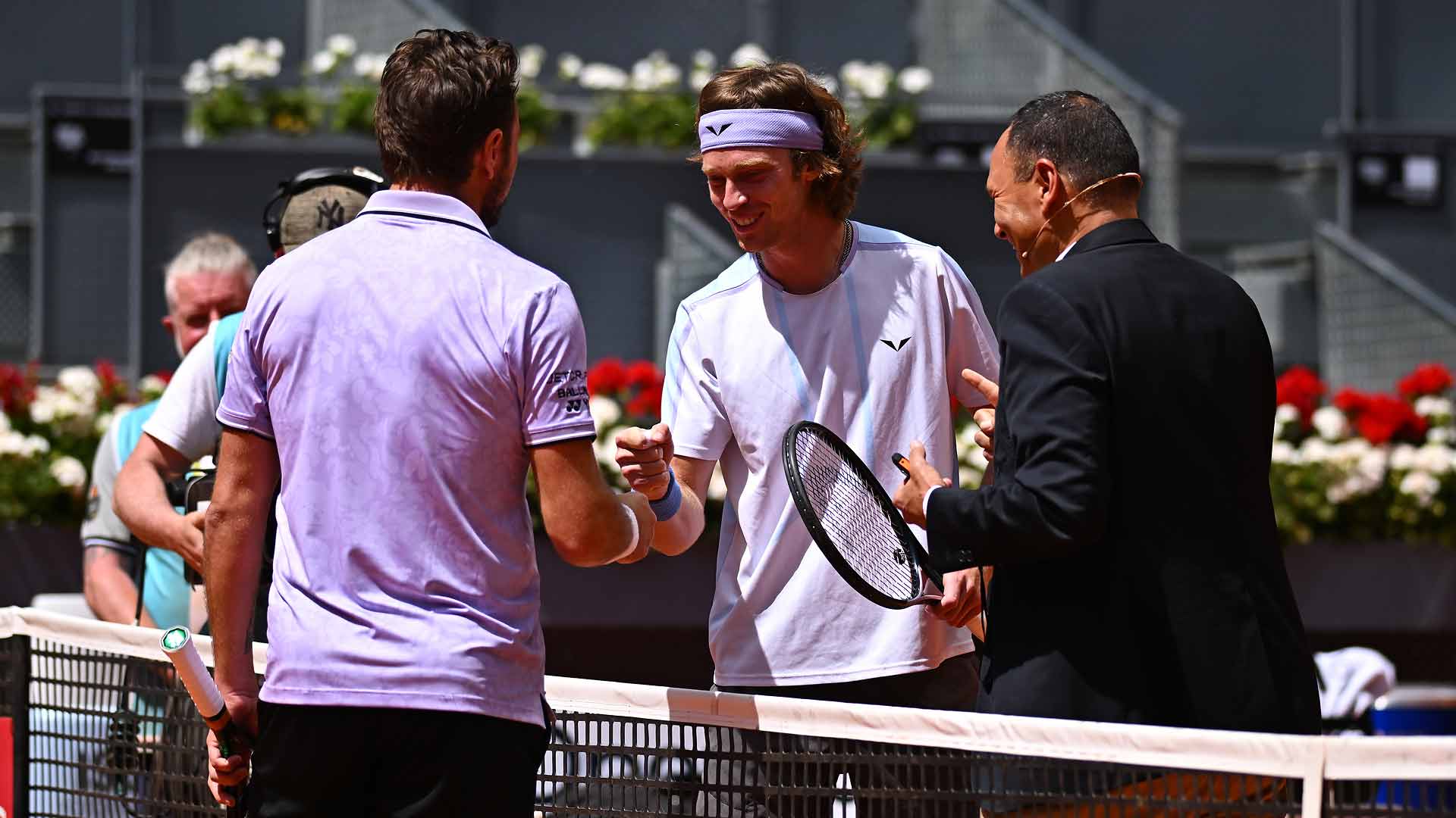 Stan Wawrinka and Andrey Rublev play a game of 'Rock, Paper; Scissors' after the coin toss goes awry on Friday in Madrid.