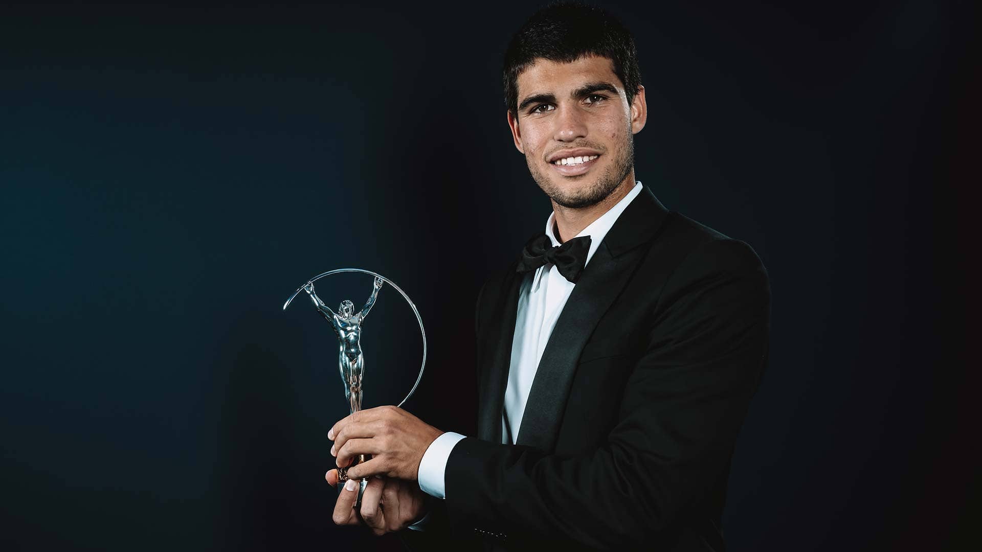 Carlos Alcaraz celebrates with his Laureus Breakthrough Of The Year Award.