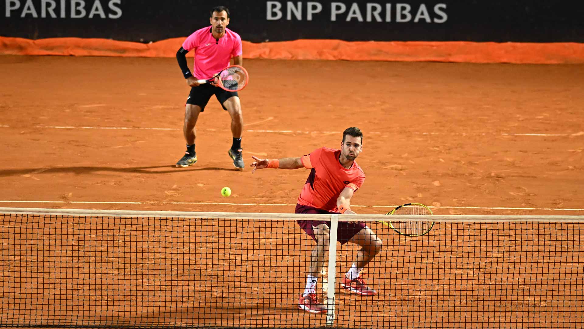 Austin Krajicek (at net) and Ivan Dodig in action at the Internazionali BNL d'Italia.