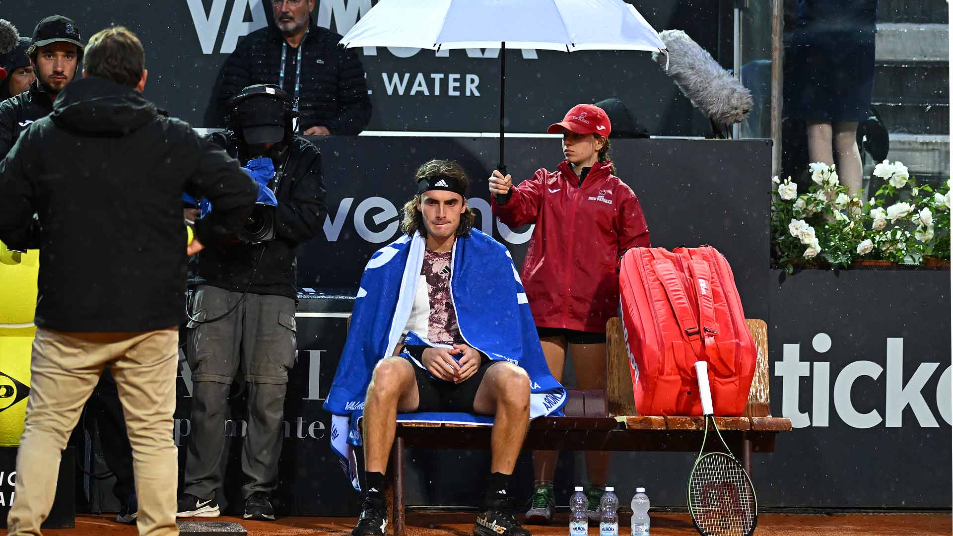 Stefanos Tsitsipas takes a one-set lead over Lorenzo Sonego on Monday in Rome, where rain suspends play.