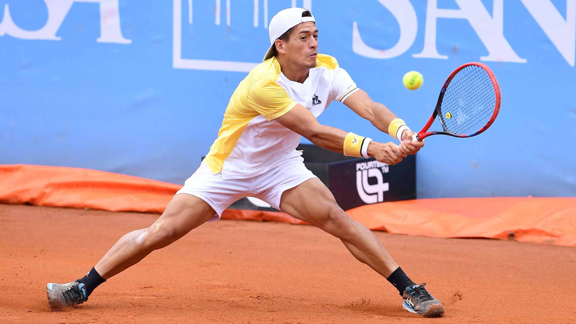 Sebastian Baez goes full stretch for a backhand at the Turin Challenger.