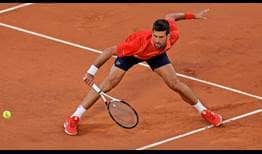 Novak Djokovic slides in for a backhand volley against Marton Fucsovics on Wednesday in Paris.