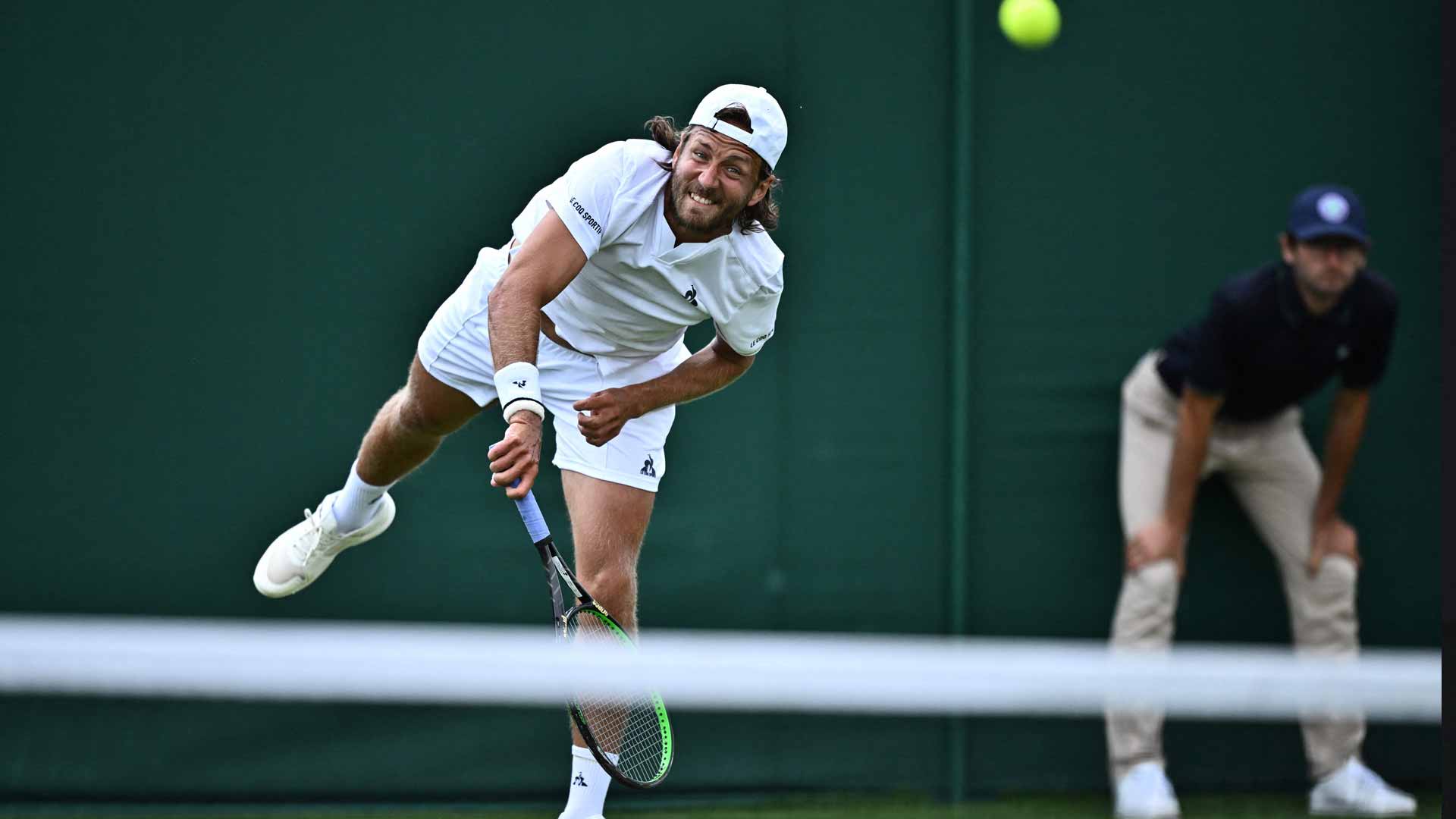 Lucas Pouille wins a three-setter on Monday to reach the second round of Wimbledon qualifying.