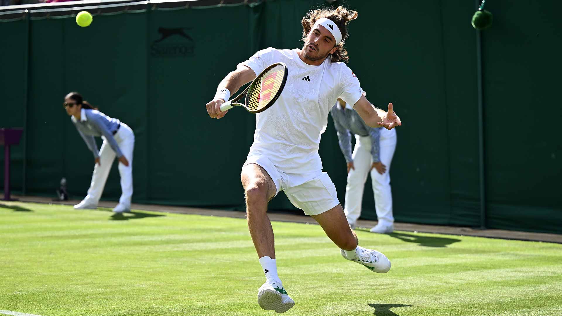 Stefanos Tsitsipas defeats Dominic Thiem in five sets to reach the second round at Wimbledon.