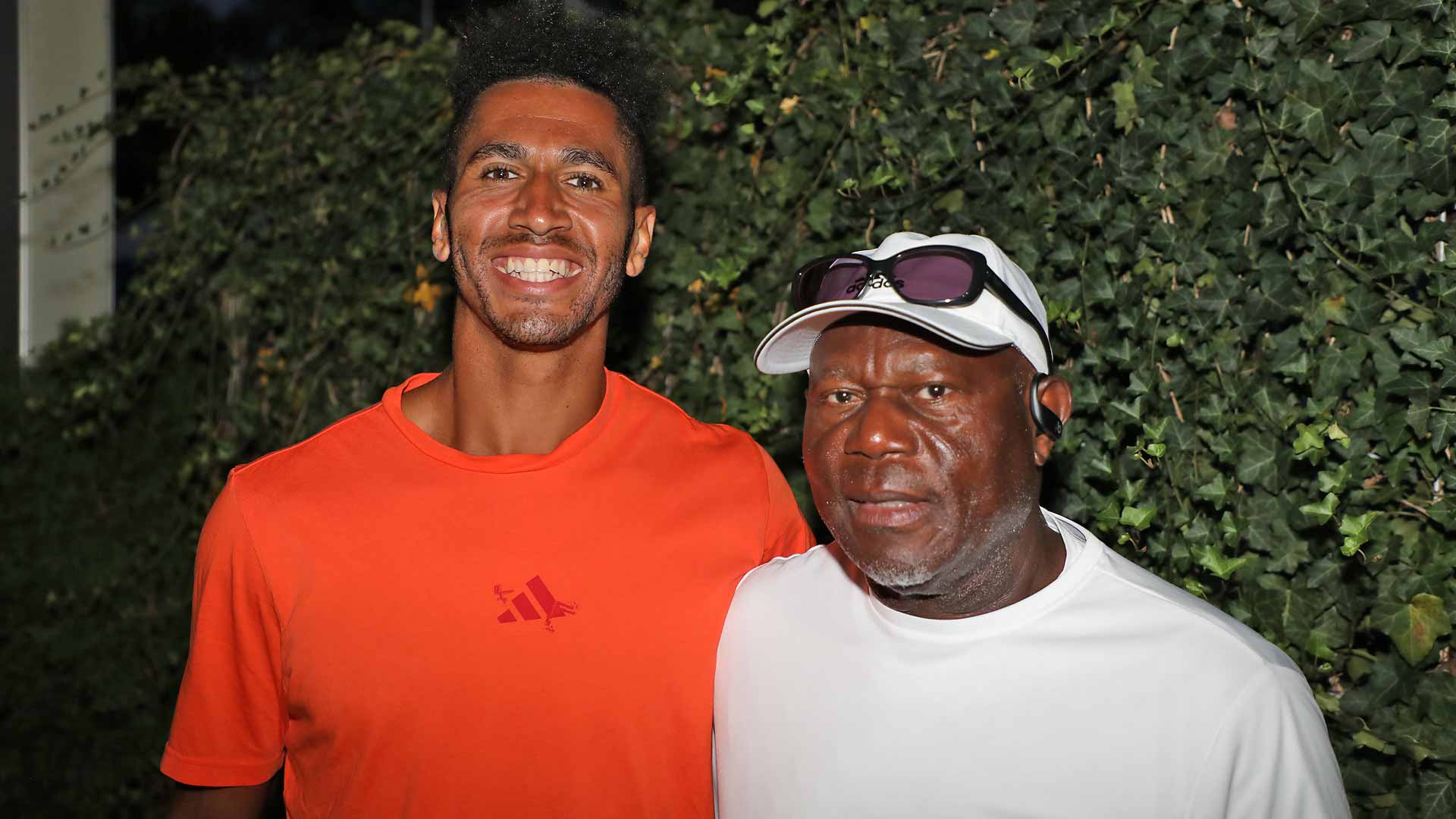 Michael Mmoh poses for a photo with his father and former professional, Tony Mmoh.