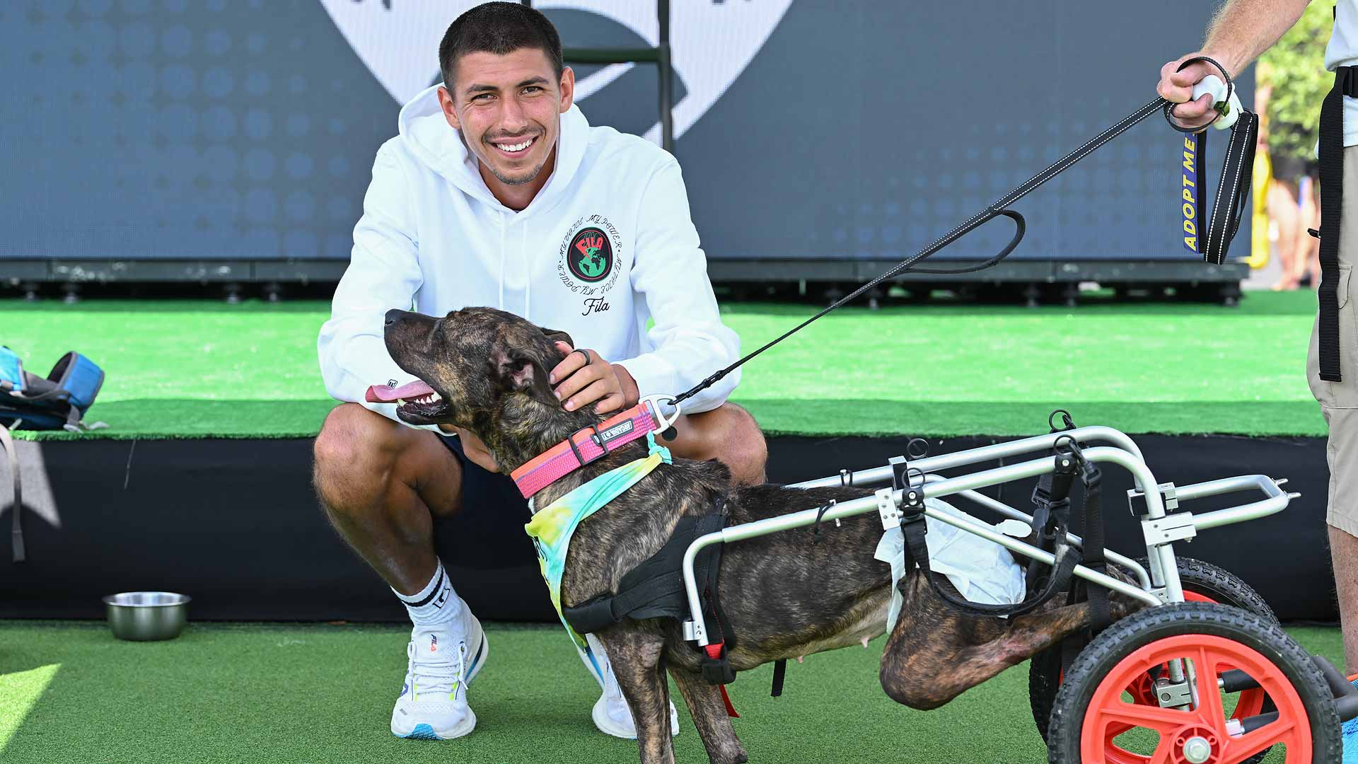Alexei Popyrin poses for a photo with Roulette of the Cincinnati Animal Care Shelter & Resource Centre on Wednesday at the Western & Southern Open.