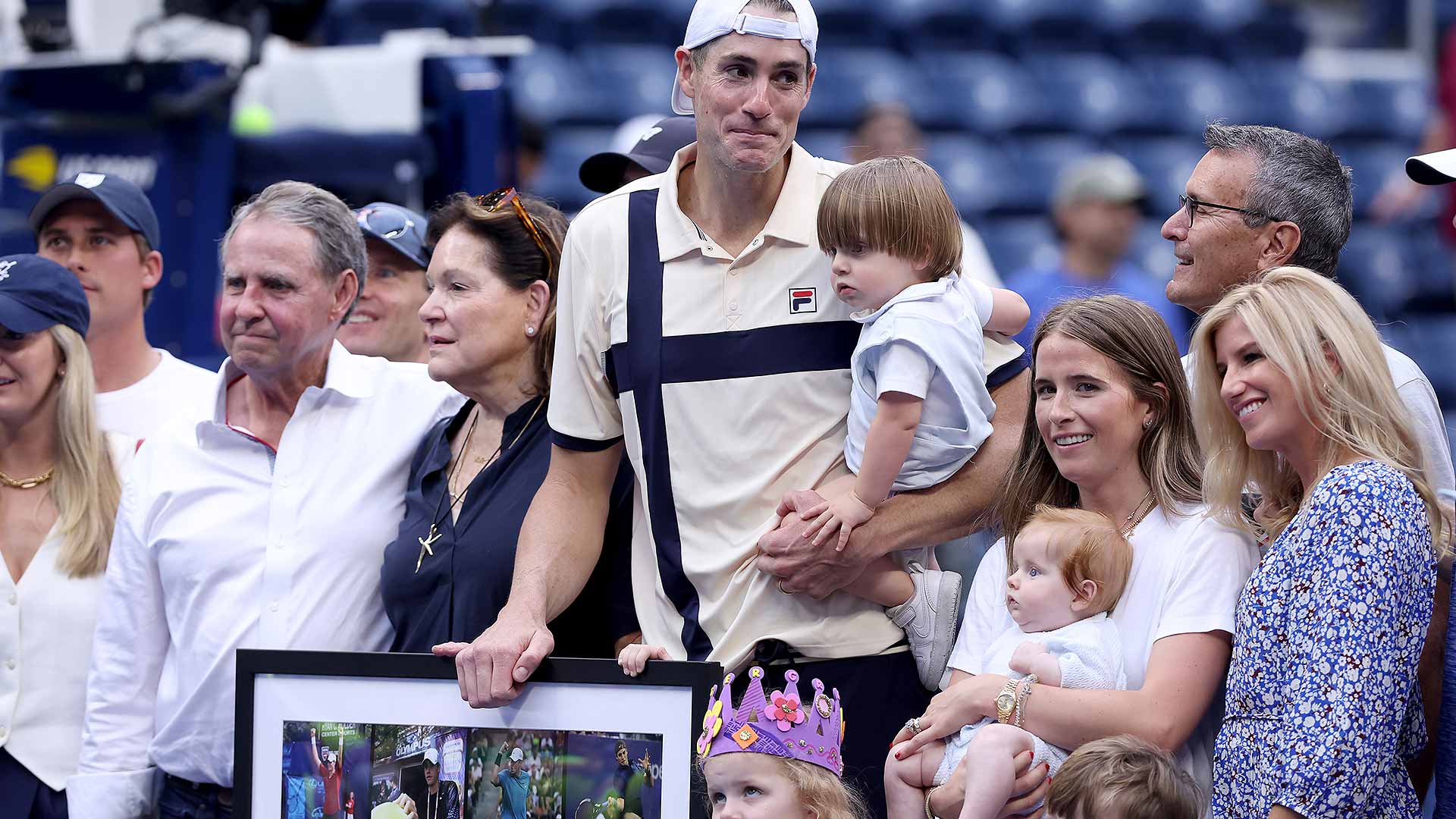 John Isner celebrates his first-round win at the US Open with his family and team.