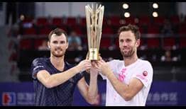 Jamie Murray and Michael Venus lift the trophy in Zhuhai.