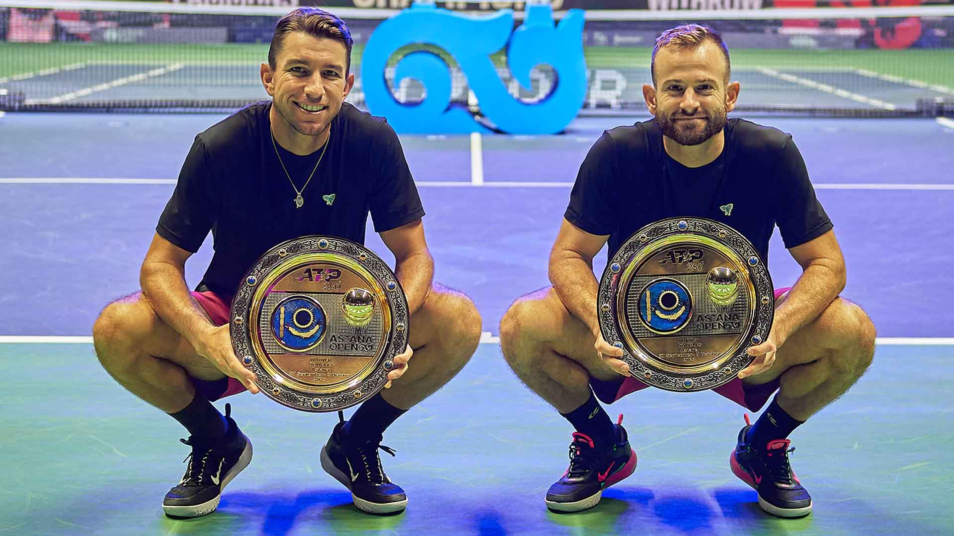 Jackson Withrow and Nathaniel Lammons celebrate in Astana on Tuesday.