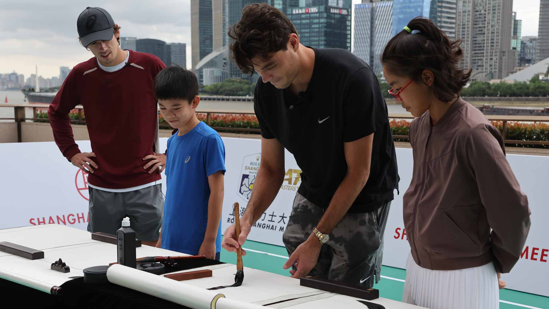 Alex de Minaur (left) and Taylor Fritz learn about Chinese calligraphy in Shanghai.
