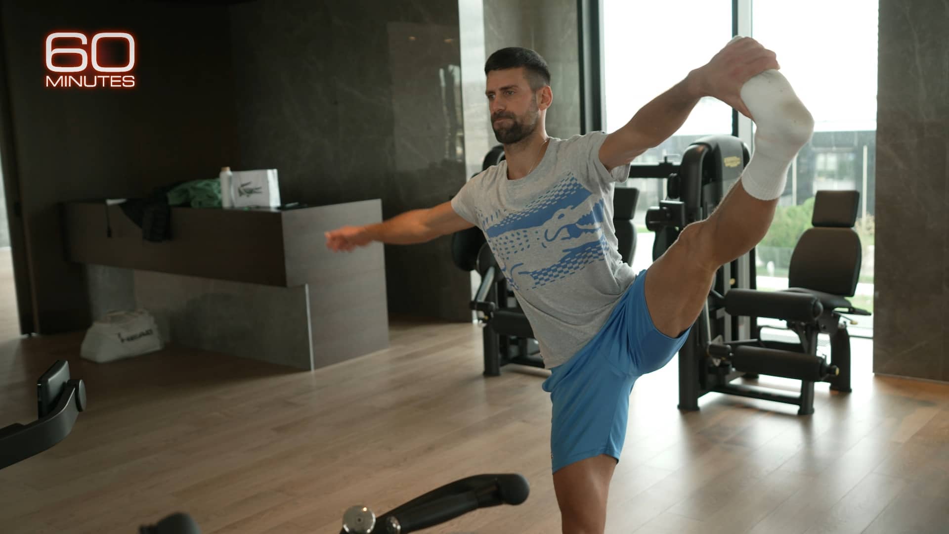 Novak Djokovic stretches during a 60 MINUTES feature on him. 