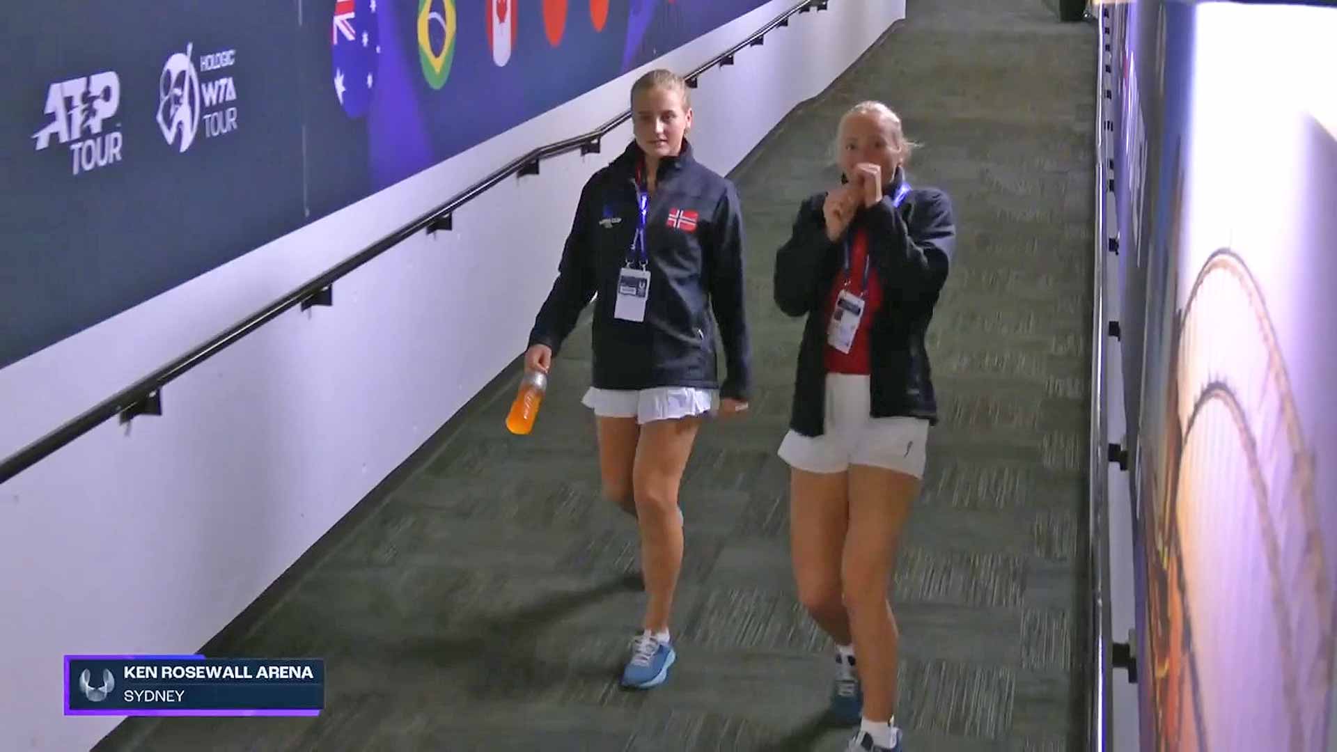 Casper Ruud's cousin and sister walk down a tunnel to Ken Rosewall Arena in Sydney.