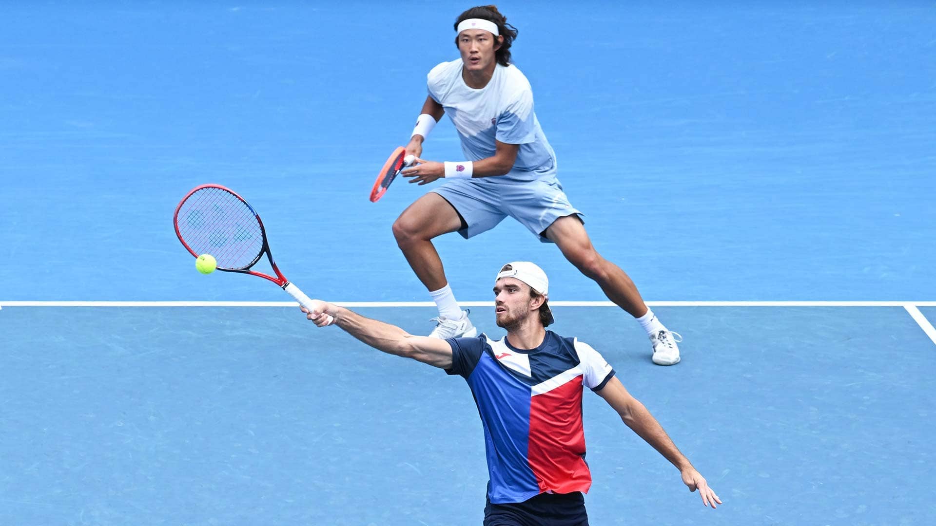 Tomas Machac and Zhang Zhizhen in action on Sunday in Melbourne.