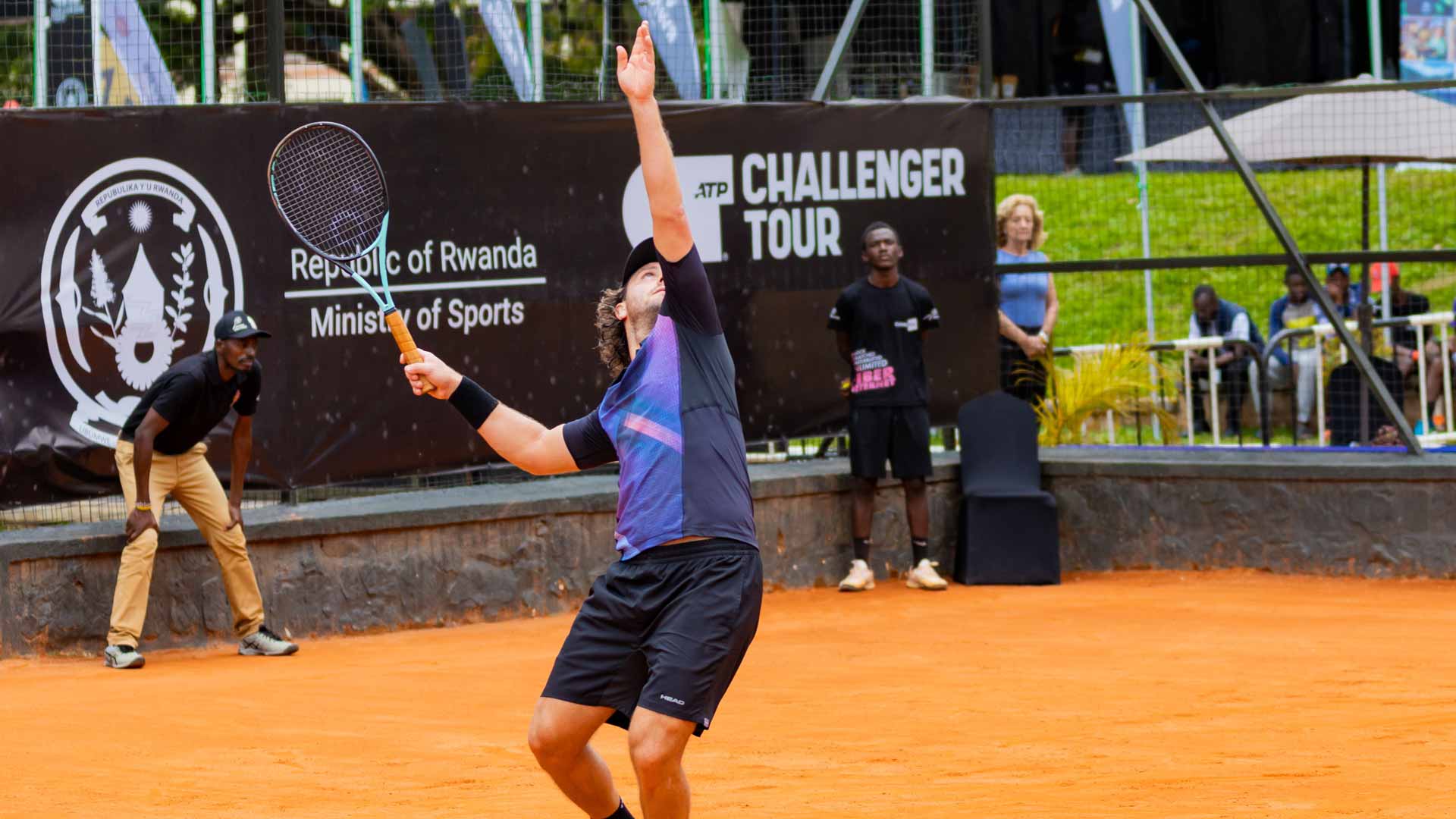 <a href='https://www.atptour.com/en/players/marco-trungelliti/ta29/overview'>Marco Trungelliti</a> in action while his mother Susana looks on.