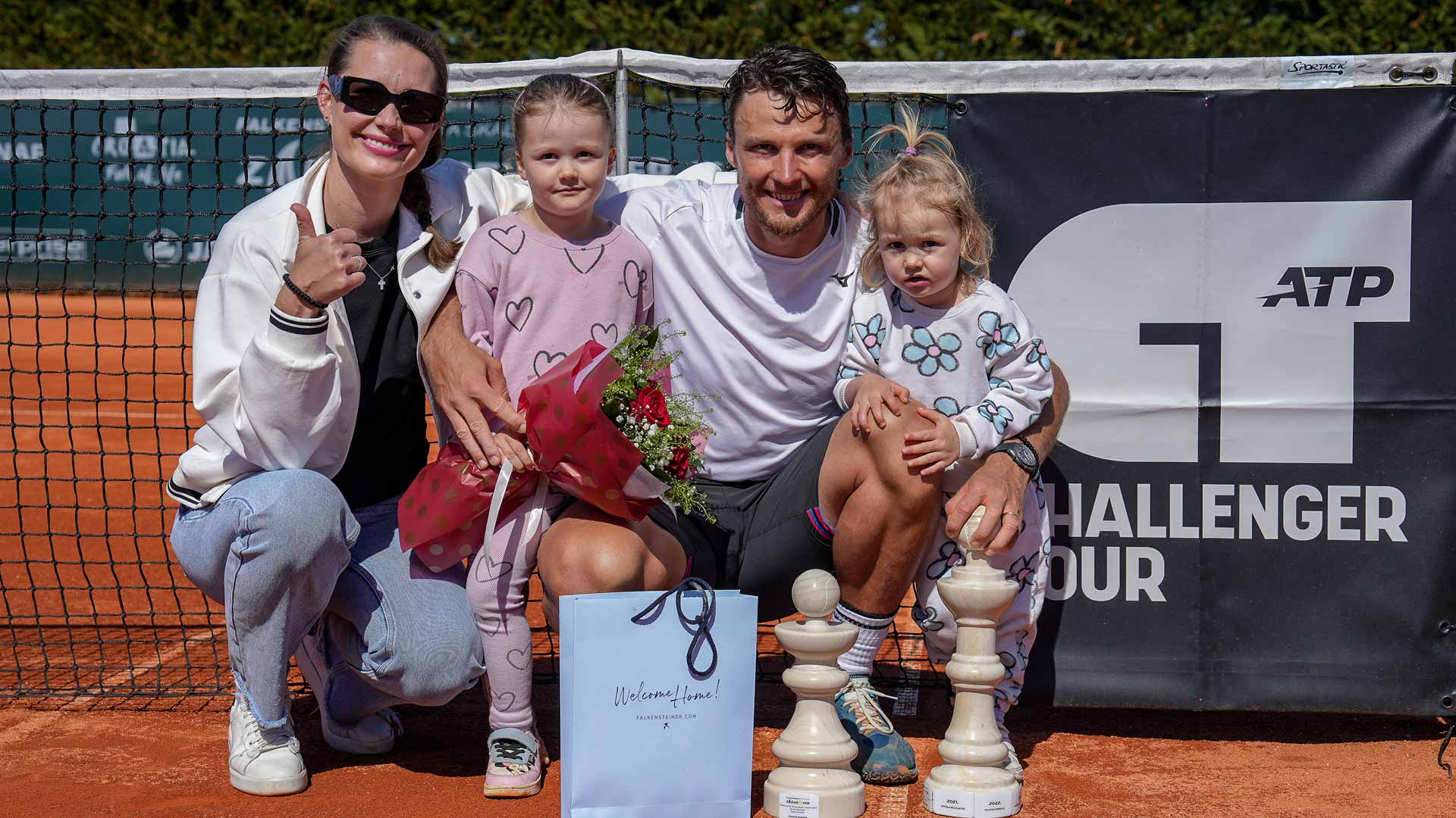 <a href='https://www.atptour.com/en/players/jozef-kovalik/kc04/overview'>Jozef Kovalik</a> celebrates winning the Zadar Challenger with his wife Nikola and daughters Nikola and Olivia.