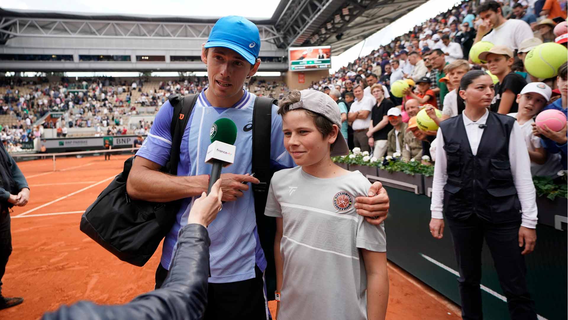 Alex de Minaur celebrates his fourth-round Roland Garros win with his special fan.