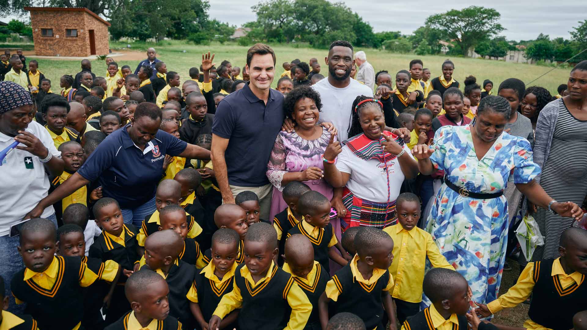 Roger Federer and rugby star Siya Kolisi with Grade R learners and staff from a primary school in Mpumalanga.