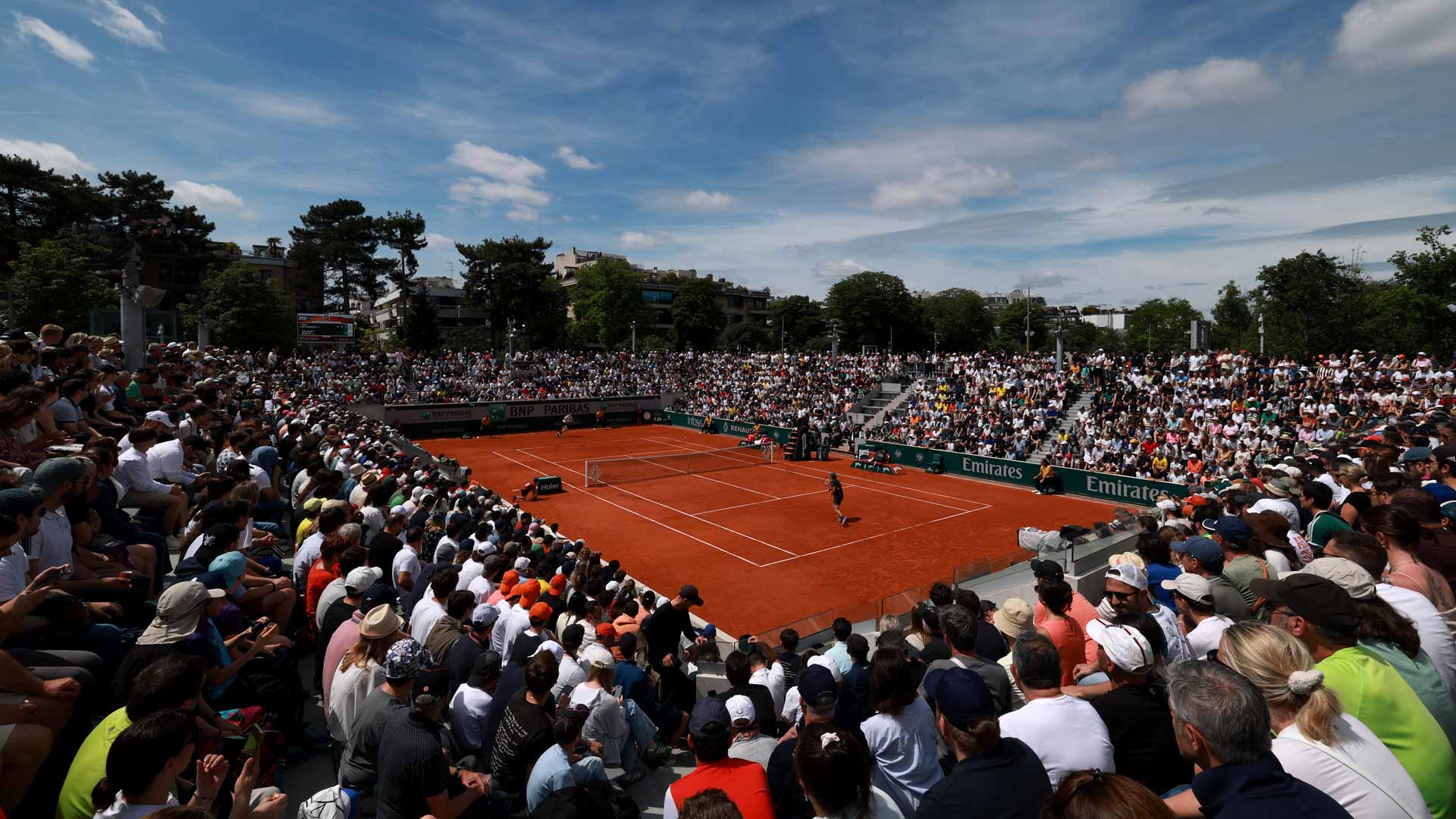 A packed Court 14 crowd watches Alexander Bublik rally from two sets to love down Thursday.