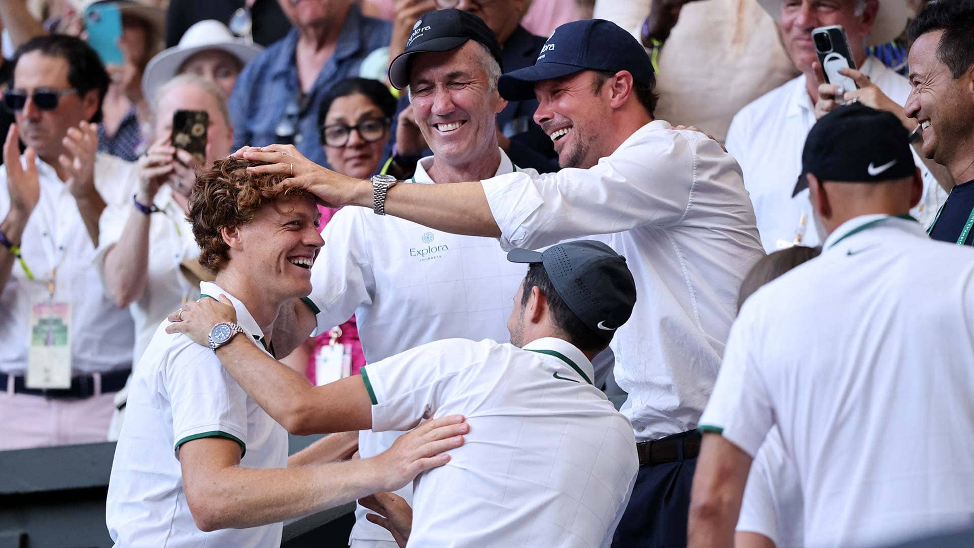 Jannik Sinner celebrates with his team after winning Wimbledon for the second time on Sunday.