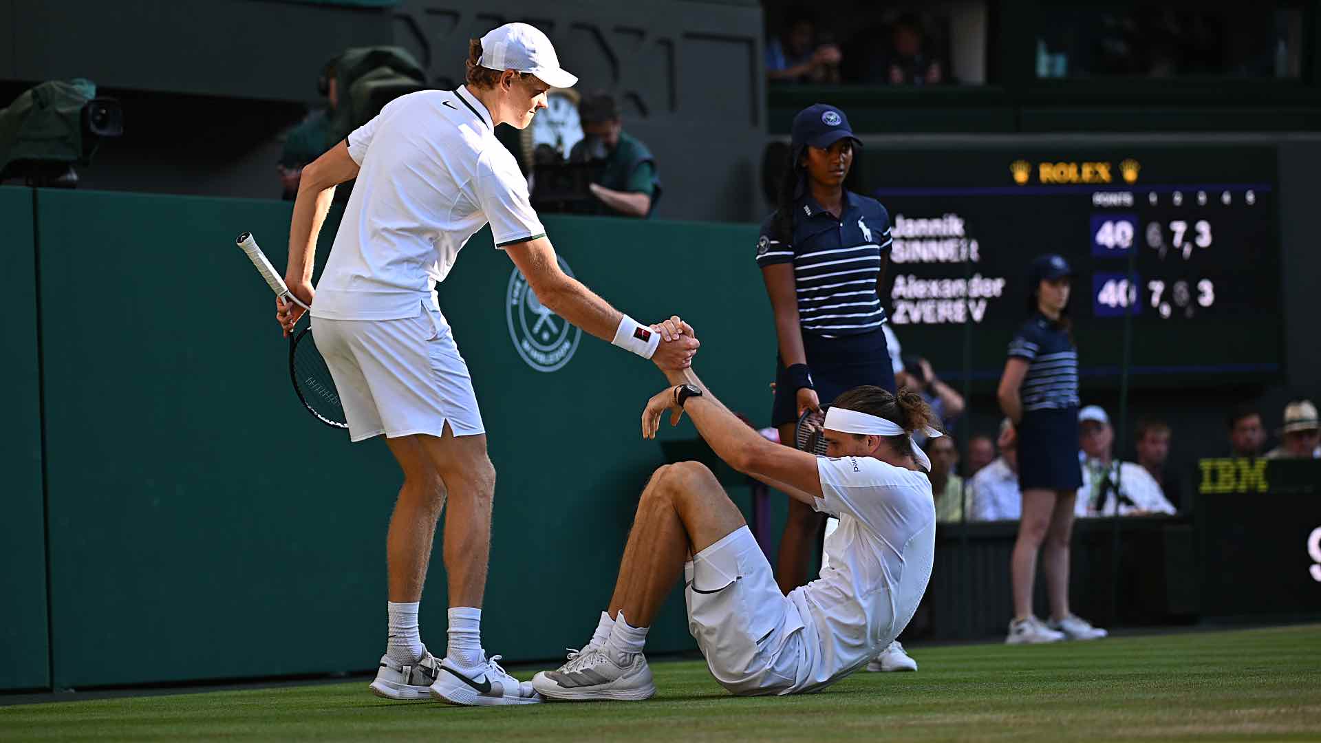 <a href='https://www.atptour.com/en/players/jannik-sinner/s0ag/overview'>Jannik Sinner</a> helps <a href='https://www.atptour.com/en/players/alexander-zverev/z355/overview'>Alexander Zverev</a> up after the German slipped on Sunday in the <a href='https://www.atptour.com/en/tournaments/wimbledon/540/overview'>Wimbledon</a> final.