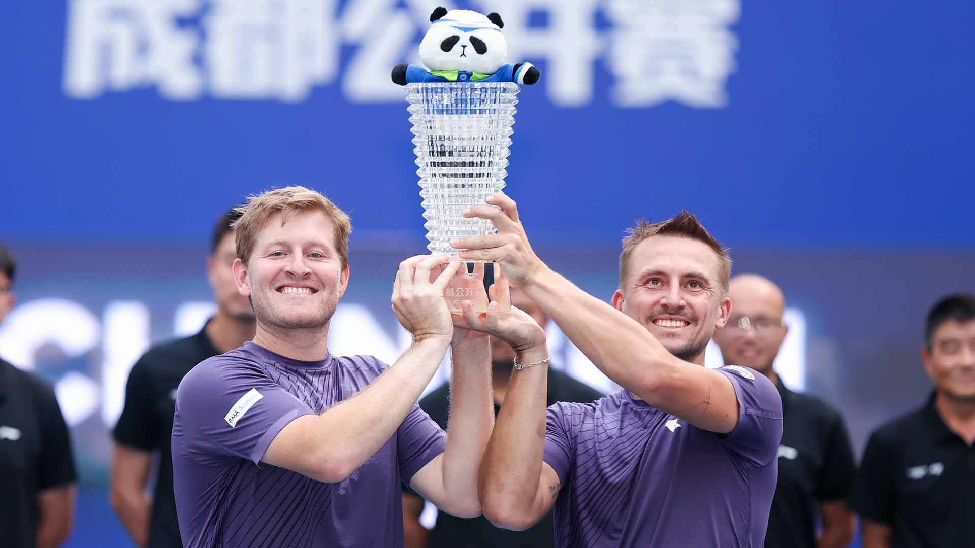 Luke Johnson and Jan Zielinski celebrate their title at the Chengdu Open on Tuesday. 